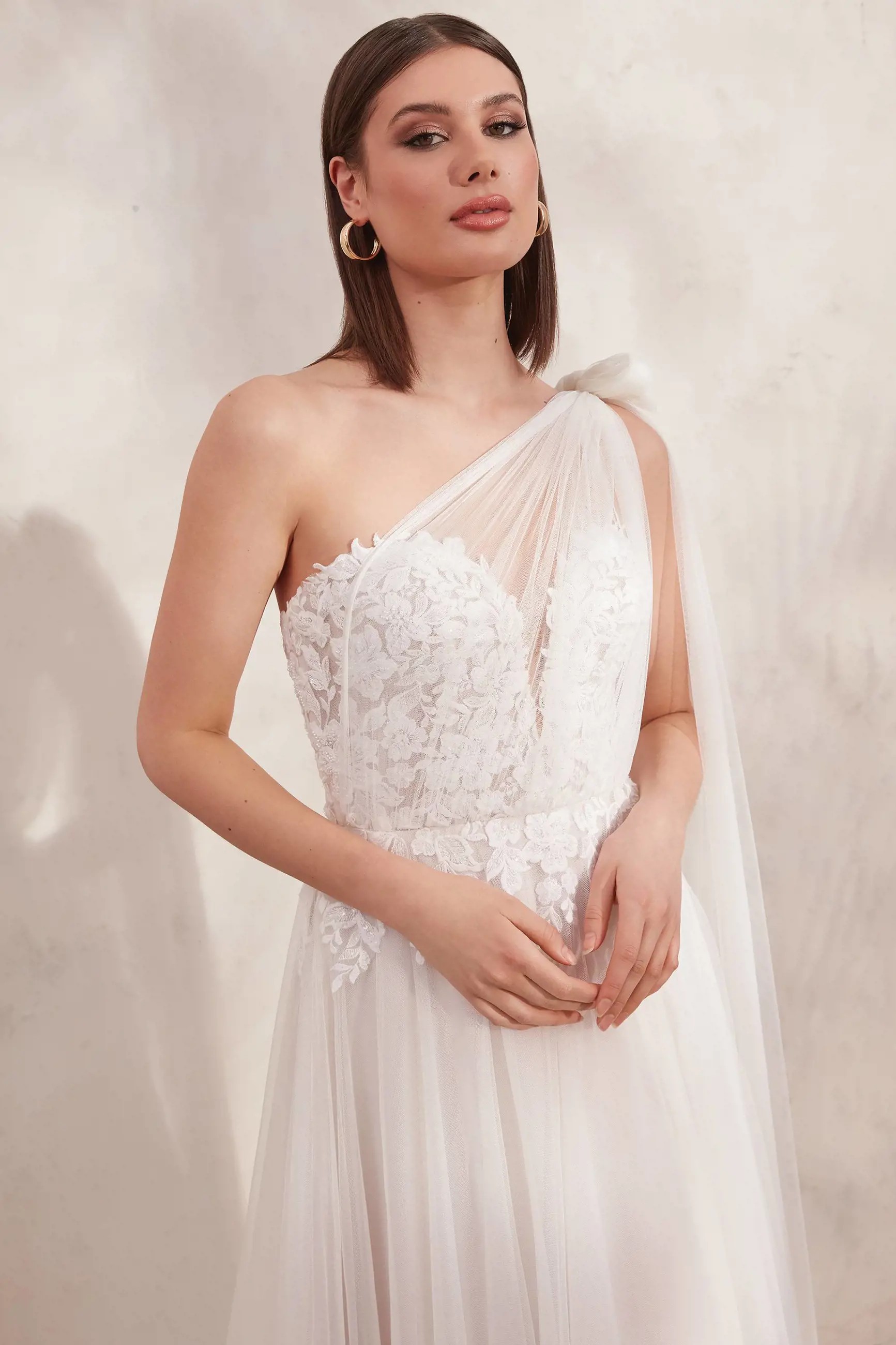 Model wearing a white gown by Adore. Desktop Image