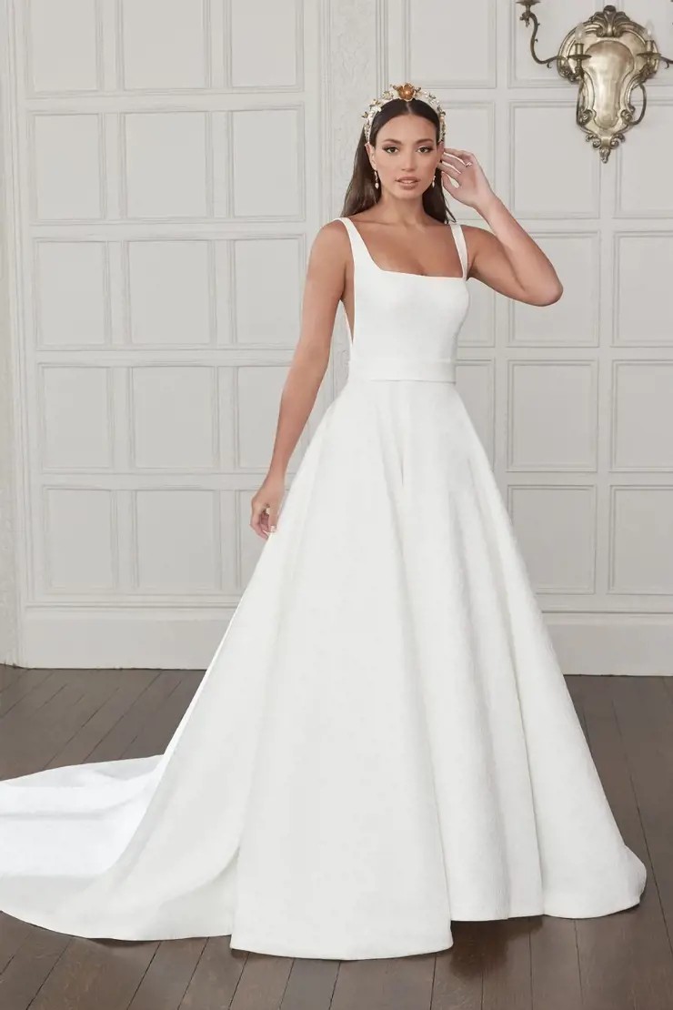 Model wearing a white gown by Justin Alexander Sincerity. Desktop Image
